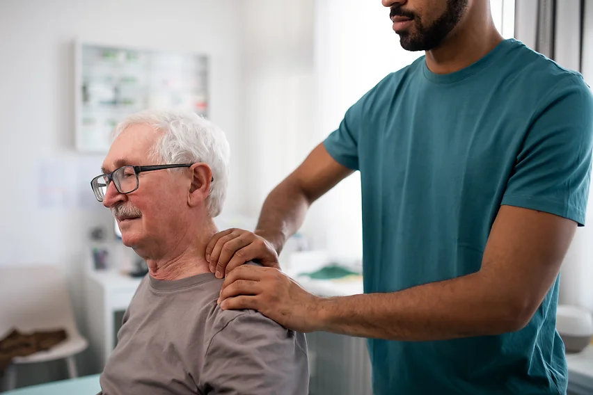 young-physiotherapist-massaging-the-neck-of-senior-2022-02-02-06-29-58-utc